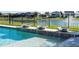 Close-up of the pool featuring decorative water fountains and a shallow sun shelf area for relaxation at 10427 Royal Cypress Way, Orlando, FL 32836
