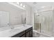 This bathroom features a glass-enclosed shower, double sink vanity, and neutral color palette at 11686 Water Run Aly, Windermere, FL 34786