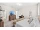 Bedroom with carpet features a TV, dresser, and desk, offering plenty of space and comfort at 11686 Water Run Aly, Windermere, FL 34786