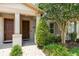Inviting front entrance featuring a well-kept garden, decorative plants, and a brick pathway at 11686 Water Run Aly, Windermere, FL 34786