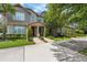 Beautiful townhome featuring lush landscaping, mature trees, and a serene view, creating a welcoming atmosphere at 11686 Water Run Aly, Windermere, FL 34786