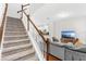 Bright and spacious living area with carpeted stairs, modern furniture, and an open layout, perfect for entertaining at 11686 Water Run Aly, Windermere, FL 34786