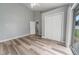 Bright bedroom boasts updated flooring, natural light, and a double door closet for ample storage space at 1184 Calanda Ave, Orlando, FL 32807