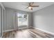 Bedroom featuring wood-look floors, ceiling fan, and natural light at 1184 Calanda Ave, Orlando, FL 32807