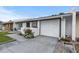 A single-story home featuring a white exterior with gray trim, an attached single car garage and newly landscaped yard at 1184 Calanda Ave, Orlando, FL 32807