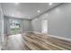 Spacious living room featuring luxury vinyl plank flooring, a large window and light gray walls at 1184 Calanda Ave, Orlando, FL 32807
