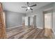 Spacious main bedroom featuring wood-look floors, ceiling fan, closet and attached bath at 1184 Calanda Ave, Orlando, FL 32807