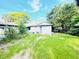 View of a backyard with green grass and some trees at 1403 N Fern Creek Ave, Orlando, FL 32803