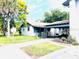 Home exterior featuring a carport, a small lawn and chain link fence at 1403 N Fern Creek Ave, Orlando, FL 32803