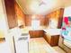 Functional kitchen boasts classic cabinetry, white appliances and a window for natural light at 1403 N Fern Creek Ave, Orlando, FL 32803