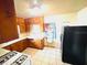Efficient kitchen layout with abundant wood cabinets, white countertops, and access to outdoor space at 1403 N Fern Creek Ave, Orlando, FL 32803