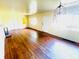 Open living room featuring hardwood floors, bright natural light, and classic chandelier fixture at 1403 N Fern Creek Ave, Orlando, FL 32803