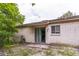 Exterior of the home showing access to the backyard through sliding glass doors and mature landscape at 1421 Summit Hill Dr, Deltona, FL 32725