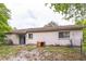 Exterior of the home showing access to the backyard through sliding glass doors and mature landscape at 1421 Summit Hill Dr, Deltona, FL 32725