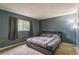 Bedroom with gray walls, carpeted floor, and a window with dark curtains at 1421 Summit Hill Dr, Deltona, FL 32725