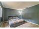 Cozy bedroom with a large bed, neutral carpet, and modern floor lamp at 1421 Summit Hill Dr, Deltona, FL 32725