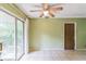 Open dining area with a ceiling fan and sliding glass doors to the backyard at 1421 Summit Hill Dr, Deltona, FL 32725