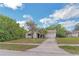 Charming single-story home featuring an attached garage and mature landscaping in the front yard at 1421 Summit Hill Dr, Deltona, FL 32725