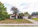 Charming single-story home featuring a front yard with mature trees and a driveway at 1421 Summit Hill Dr, Deltona, FL 32725