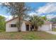 Charming single-story home featuring an attached garage and mature landscaping in the front yard at 1421 Summit Hill Dr, Deltona, FL 32725