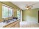 The kitchen sink offers a large window offering views of the outdoors and ample natural light at 1421 Summit Hill Dr, Deltona, FL 32725