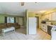 Open concept living area with easy access to the kitchen featuring neutral tile flooring throughout the home at 1421 Summit Hill Dr, Deltona, FL 32725