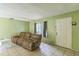 Inviting living room features tile flooring, a comfortable couch, and a bright window for natural light at 1421 Summit Hill Dr, Deltona, FL 32725