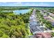 A scenic aerial view of a lake with houses along the shore, featuring lush greenery and a neighborhood setting at 14213 Southern Red Maple Dr, Orlando, FL 32828
