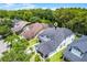 Aerial view of a beautiful home showcasing its architectural details and surrounding lush greenery at 14213 Southern Red Maple Dr, Orlando, FL 32828