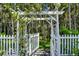 Charming backyard gate framed by lush greenery and a quaint arbor at 14213 Southern Red Maple Dr, Orlando, FL 32828