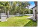 Lush backyard with green grass, a storage unit, and a white picket fence at 14213 Southern Red Maple Dr, Orlando, FL 32828