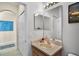Well-lit bathroom featuring a large mirror, a stylish sink, and ample storage space at 14213 Southern Red Maple Dr, Orlando, FL 32828