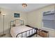 Bedroom with carpet flooring, a metal frame bed, and a window for natural light at 14213 Southern Red Maple Dr, Orlando, FL 32828