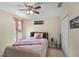 Cozy bedroom with natural light, a ceiling fan, neutral walls and a comfortable bed at 14213 Southern Red Maple Dr, Orlando, FL 32828