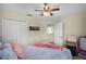 Bedroom featuring closet, ceiling fan, natural light, and comfortable bed at 14213 Southern Red Maple Dr, Orlando, FL 32828