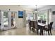 Inviting dining room featuring a modern chandelier and sliding glass doors to the outdoor area at 14213 Southern Red Maple Dr, Orlando, FL 32828