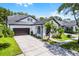 A beautiful front view of a home with well-maintained landscaping, a spacious driveway, and a two-car garage at 14213 Southern Red Maple Dr, Orlando, FL 32828