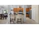 Bright kitchen featuring wood cabinets, stainless steel appliances, and a breakfast bar with seating at 14213 Southern Red Maple Dr, Orlando, FL 32828