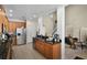 Well-equipped kitchen featuring granite countertops, stainless steel appliances, modern cabinetry, and views into other living areas at 14213 Southern Red Maple Dr, Orlando, FL 32828