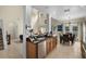 Spacious kitchen featuring granite countertops, stainless steel appliances, modern cabinetry, and views into the dining area at 14213 Southern Red Maple Dr, Orlando, FL 32828