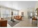 Bright living room with large windows, tile flooring, modern furniture, and a decorative area rug at 14213 Southern Red Maple Dr, Orlando, FL 32828