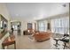 Bright and open living room with tile flooring, large windows, comfortable seating, and easy access to the dining area at 14213 Southern Red Maple Dr, Orlando, FL 32828