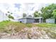 View of the side and back yard, showing a clean gray exterior and white fencing at 1530 Monica St, Deltona, FL 32725