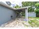 Backyard view featuring a covered patio area with access to the home's sliding glass doors at 1530 Monica St, Deltona, FL 32725