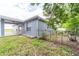 Landscaped backyard with fence and partially covered patio area connected to the house at 1530 Monica St, Deltona, FL 32725