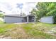Exterior backyard view with a shed and patio area connected to the home at 1530 Monica St, Deltona, FL 32725