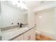 Bright bathroom featuring white cabinets, granite countertop, and a single sink vanity at 1530 Monica St, Deltona, FL 32725