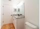 Bathroom featuring white cabinets, granite countertop, and neutral tile flooring at 1530 Monica St, Deltona, FL 32725