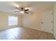 Serene bedroom with ceiling fan, tile floors, and natural lighting at 1530 Monica St, Deltona, FL 32725