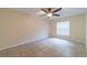 Cozy bedroom featuring tile flooring and a bright window at 1530 Monica St, Deltona, FL 32725